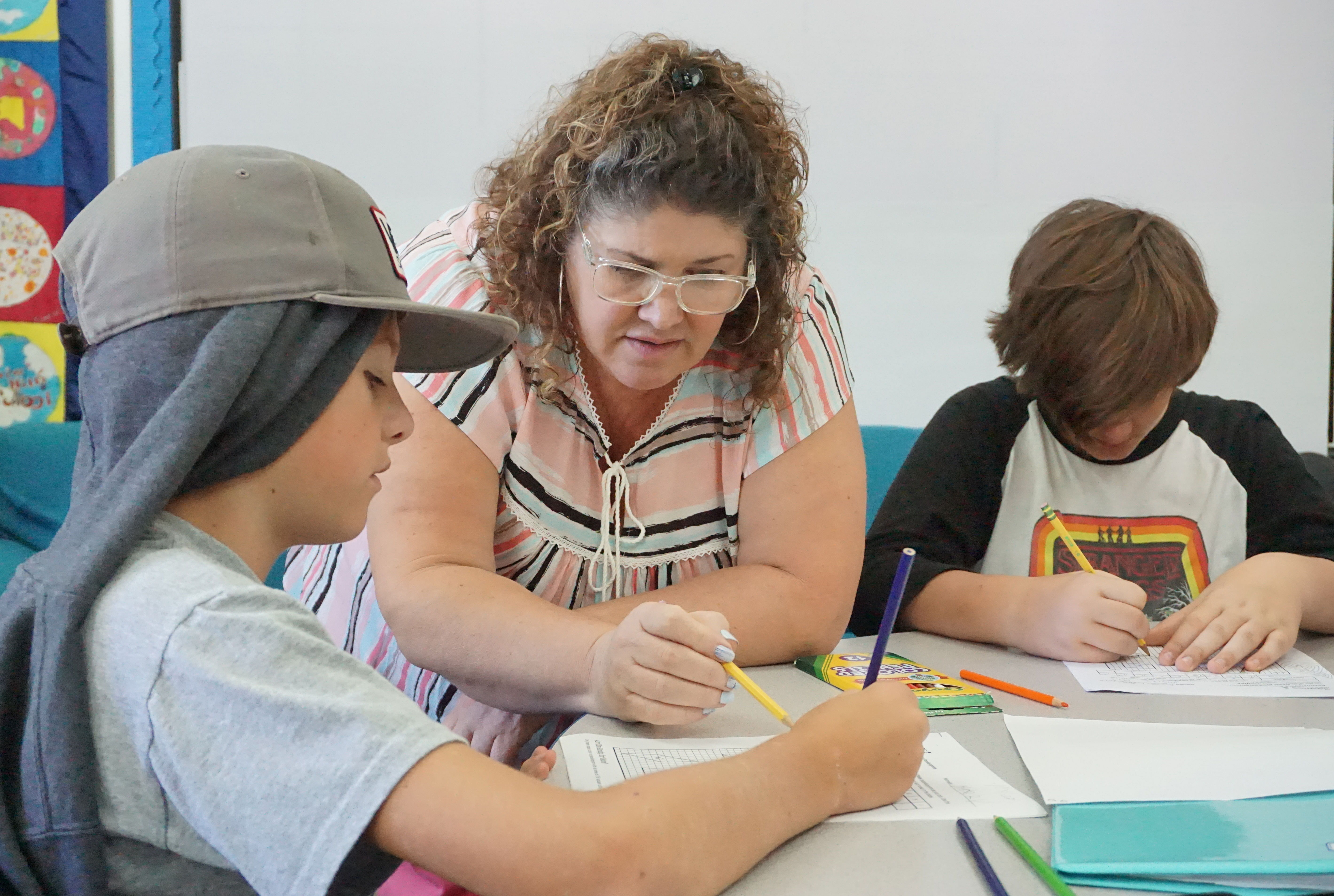 Nicole Ellwood helps two students with an assignment at Twin Hills Charter Middle School in Sebastopol on Monday, Oct. 3, 2022.